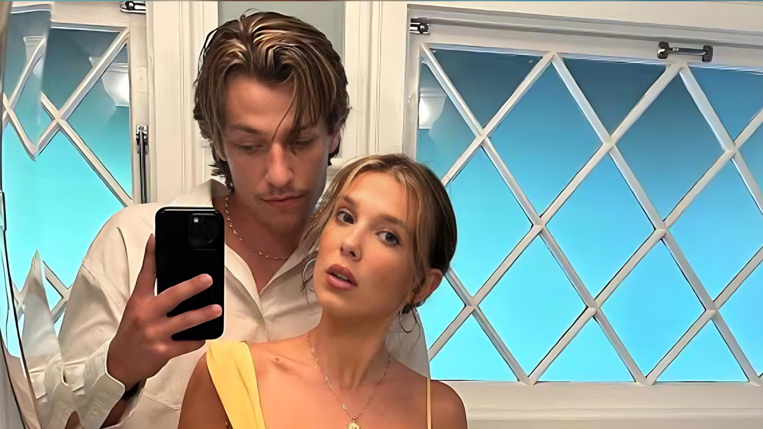 Millie Bobby Brown and husband Jake Bongiovi taking a mirror selfie together