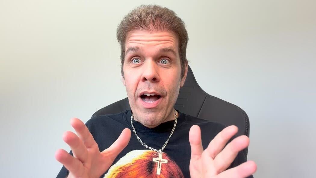 A picture of Perez Hilton wearing a black T-shirt during one of his Vlog sessions.